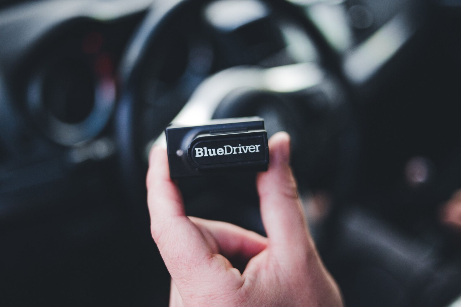 VCDS-compatible diagnostic interface connected to a vehicle OBD port